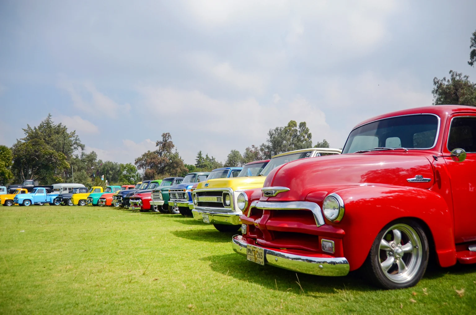 Line of polished classic cars on display at a vintage car show