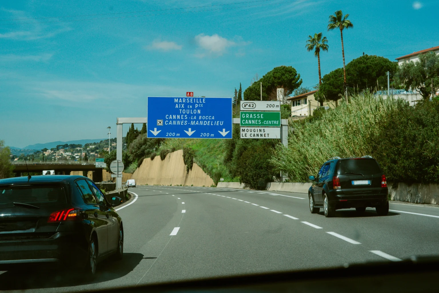 UK drivers driving in the EU on a French motorway with compliant number plates, road signs for Marseille, Toulon and Cannes.
