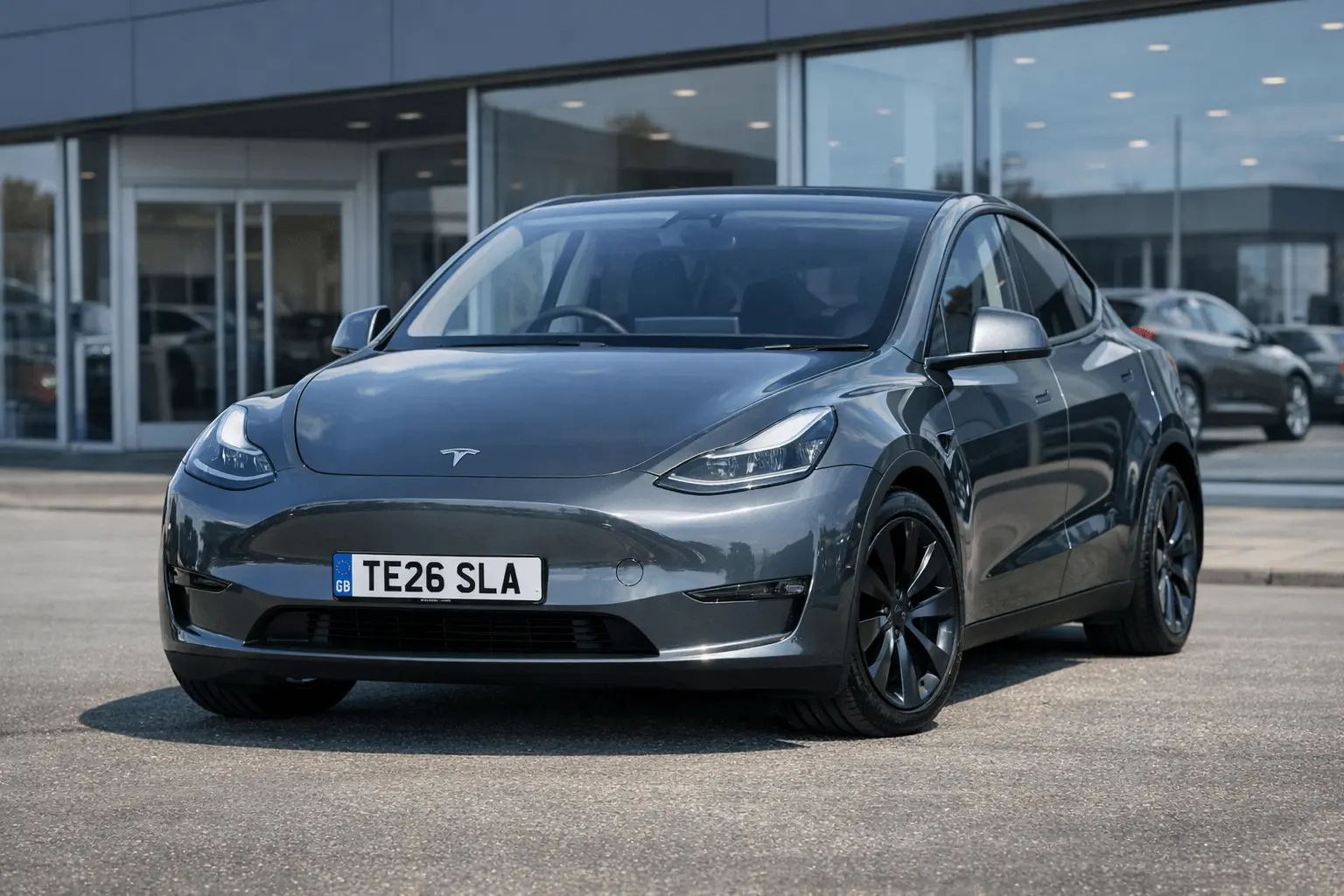 Modern Tesla Model Y parked on a UK dealership forecourt displaying a 2026 26 registration number plate TE26 SLA in daylight | JDM Plates | 7th April 2026 Modern Tesla Model Y parked on a UK dealership forecourt displaying a 2026 “26” registration number plate (TE26 SLA) in daylight