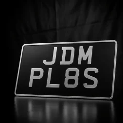 black and silver import number plates. Vintage import number plates in pressed metal.