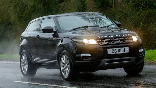 Range Rover SUV driving on a wet road with clean, standard Range Rover number plates fitted