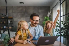 Family using a laptop at home while researching and search for a number plate to buy online.